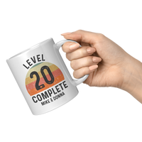 Load image into Gallery viewer, 20th_Anniversary_Mug_Level_20_Complete__11oz_White_RH_Model_Mockup.png
