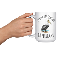 Load image into Gallery viewer, Easily_Distracted_by_Pelicans_Mug_15oz_White_LH_Model_Mockup.png
