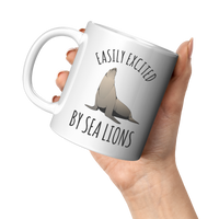 Load image into Gallery viewer, Easily_Excited_by_Sea_Lions_Mug_11oz_White_LH_Model_Mockup.png
