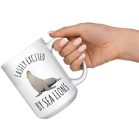 Load image into Gallery viewer, Easily_Excited_by_Sea_Lions_Mug_15oz_White_RH_Model_Mockup.png
