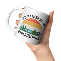 Load image into Gallery viewer, Id_Rather_Be_in_Philadelphia_Mug_11oz_White_LH_Model_Mockup.png
