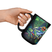 Load image into Gallery viewer, Stained_Glass_Frogs_on_a_Branch_Mug_Lifestyle_LH_Raised_Angle_Mockup.png
