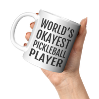 Load image into Gallery viewer, Worlds_Okayest_Pickleball_Player_Mug_11oz_White_LH_Model_Mockup.png
